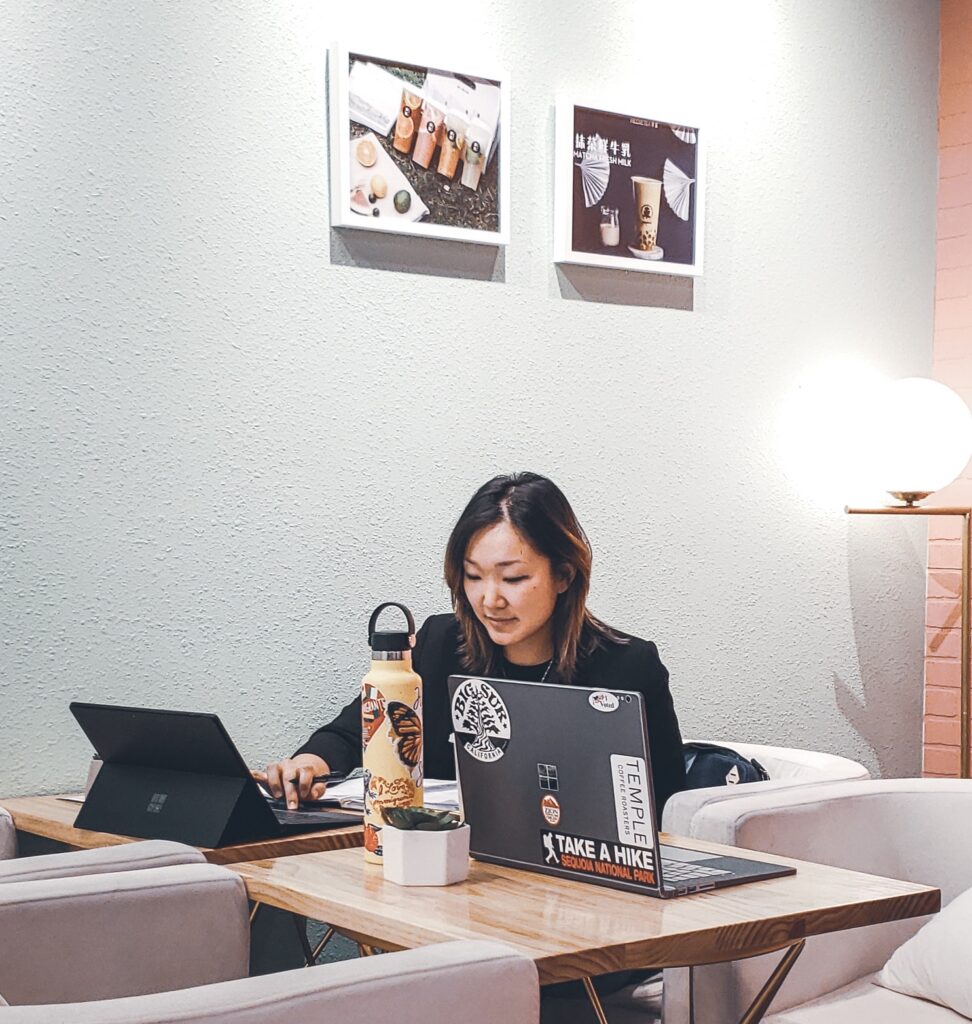 Intern working at a desk on her computer.