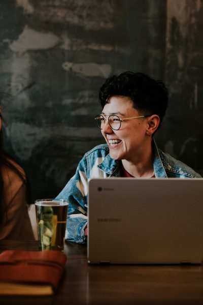 Happy international student at laptop.